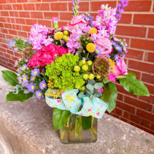 Spread joy with “Bright Love” from Flowerland Florist in Sulphur Springs, TX. Bursting with vibrant pinks, purples, yellows and greens, this cheerful arrangement is perfect for birthdays, encouragement, or simply brightening someone’s day. Local delivery available.