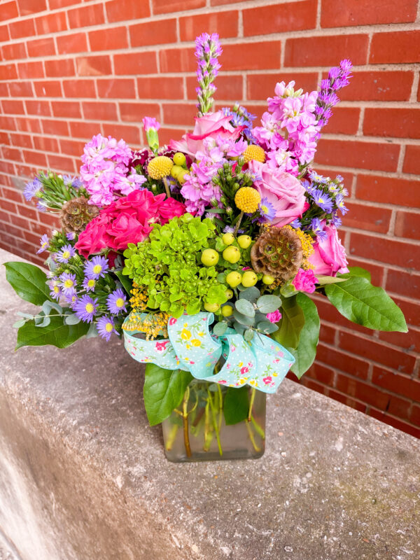 Spread joy with “Bright Love” from Flowerland Florist in Sulphur Springs, TX. Bursting with vibrant pinks, purples, yellows and greens, this cheerful arrangement is perfect for birthdays, encouragement, or simply brightening someone’s day. Local delivery available.