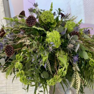 Honor a cherished life with “Reflections” from Flowerland Florist in Sulphur Springs, TX. This masculine casket spray features an elegant assortment of lush greenery and striking blue thistle—perfect for a dignified funeral tribute. Local delivery available.