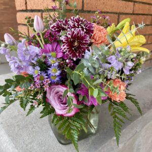 Brighten someone’s day with “Blooming Joy” from Flowerland Florist in Sulphur Springs, TX. Bursting with vibrant daisies, hydrangeas, carnations, and more in cheerful shades of pink, orange, purple, and green. A joyful floral arrangement for any occasion. Local delivery available.