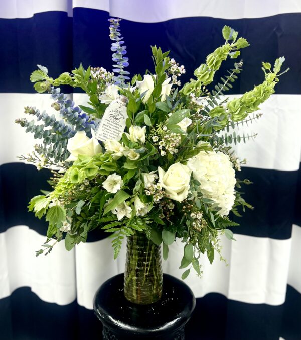 Offer comfort and peace with “Feather from an Angel” from Flowerland Florist in Sulphur Springs, TX. A serene sympathy arrangement in soft whites and greens, featuring a keepsake feather as a gentle reminder of love and presence. Local funeral delivery available.